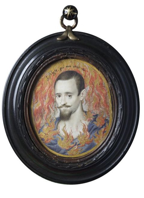Painting. An oval miniature painting of a man’s head contained within a thick, black wood frame. He has black hair and a dark, neatly trimmed beard and wears a blue top. Flames are painted across his upper chest and onto the background behind him, and a small passage of text arches over his head.