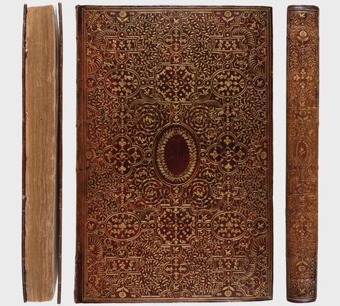 Colour photograph. The front cover of a brown leather book in portrait format adorned with intricate and ornate gold patterns is seen face on, flanked by photographs of the book from side on views, showing the spine and the pages.